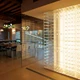 A modern restaurant interior using UltraBright™ Architectural IP20 LED Strips to highlight a neutral white feature wall.