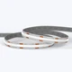 A coiled UltraBright™ Verity SOB Diffused IP20 LED Strip showing its high-quality encasing and 3M adhesive backing.