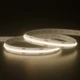 UltraBright™ Verity SOB Diffused IP20 LED Strip in a soft 3000K warm white glow while coiled on a reflective surface.