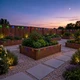 Backyard garden raised beds and fence line illuminated at dusk with the Leona® Smart RGB Eave Lighting Kit’s colorful accents.