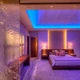 Luxury bedroom featuring blue tray ceiling lighting and warm headboard accents with a ColorBright™ RGB 300 IP20 LED Strip.