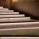 Cool UltraBright™ Outline IP20 LED Strips installed under wooden stair treads for modern, safe accents and guide lights.