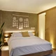 Warm UltraBright™ Outline IP20 LED Strips glow behind a headboard, lighting a textured wall with a dreamcatcher in a bedroom.