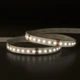 Outdoor UltraBright™ Outline IP65 LED Strip illuminated in a soft 3000K warm white glow while coiled on a reflective surface.