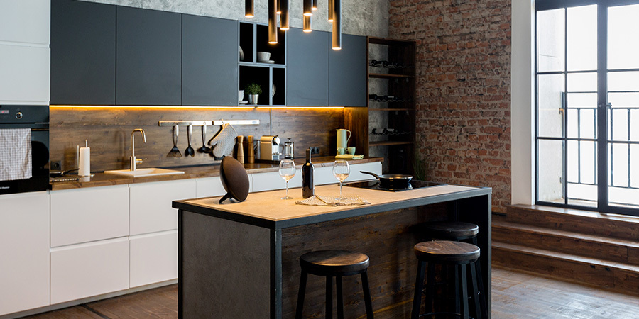Modern kitchen with LED undercabinet lights, wood countertop and gray cabinets