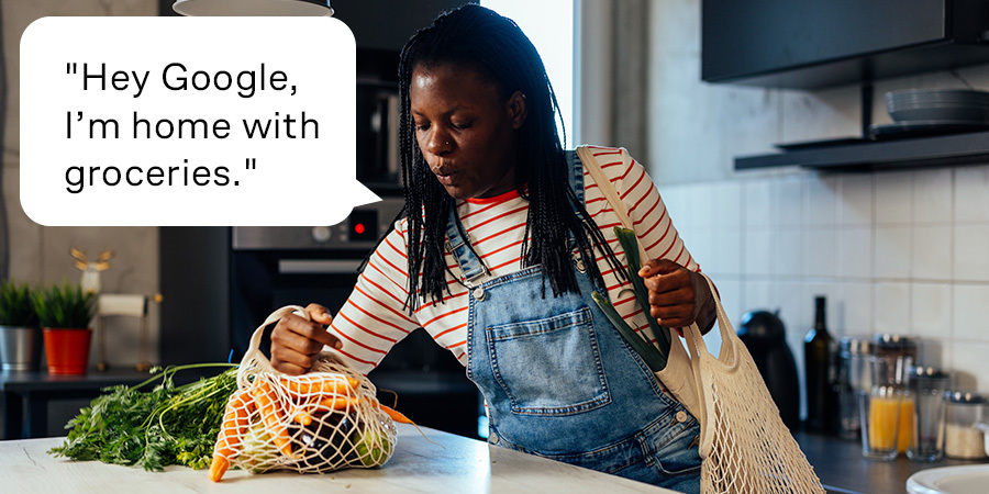 Person controlling lights with Google/Alex voice commands through Leona Smart app