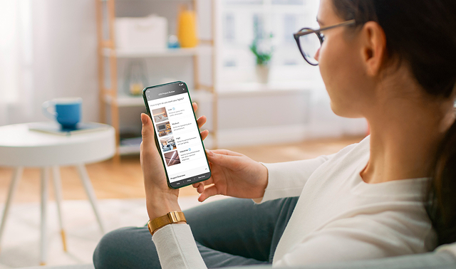 A woman using the Flexfire LED project builder on her smartphone.
