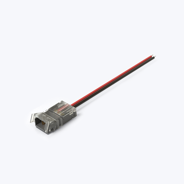 A closeup image of an LED strip light connector with bare wires at one end