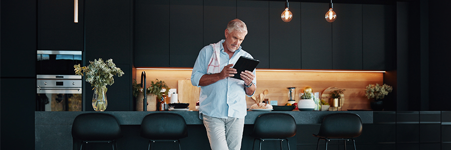 Kitchen Smart Lights: 12 Best Ideas for Modern Cooking & Living Blog Banner - Person using tablet to control LED lights