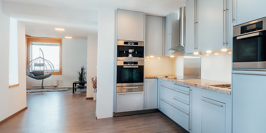 Kitchen under-cabinet lighting with Victory Select LED puck lights illuminating white cabinetry