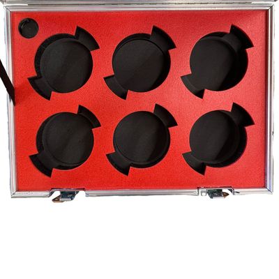 Red-topped foam insert cut for six lenses
