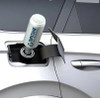 Pouring Dipetane fuel treatment into a car fuel tank