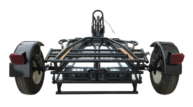 Motorcycle loaded on the Alpha Sport Stand-Up Motorcycle Trailer with wheel chock and ramp for secure transport.