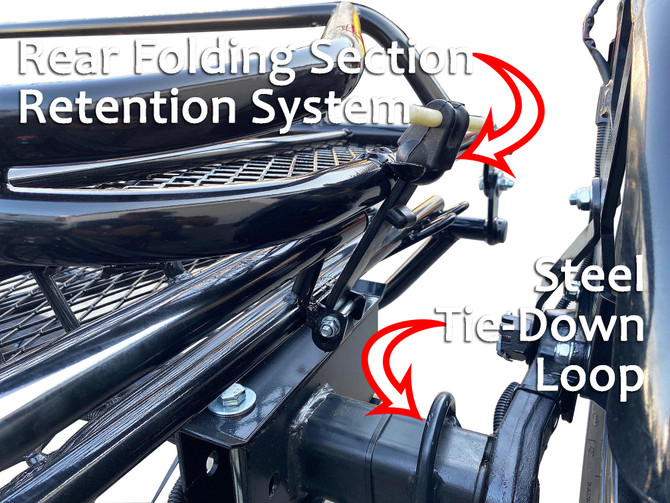 Labeled view of the Freestyle dirt bike trailer’s retention system showing tie-down points and support structure.
