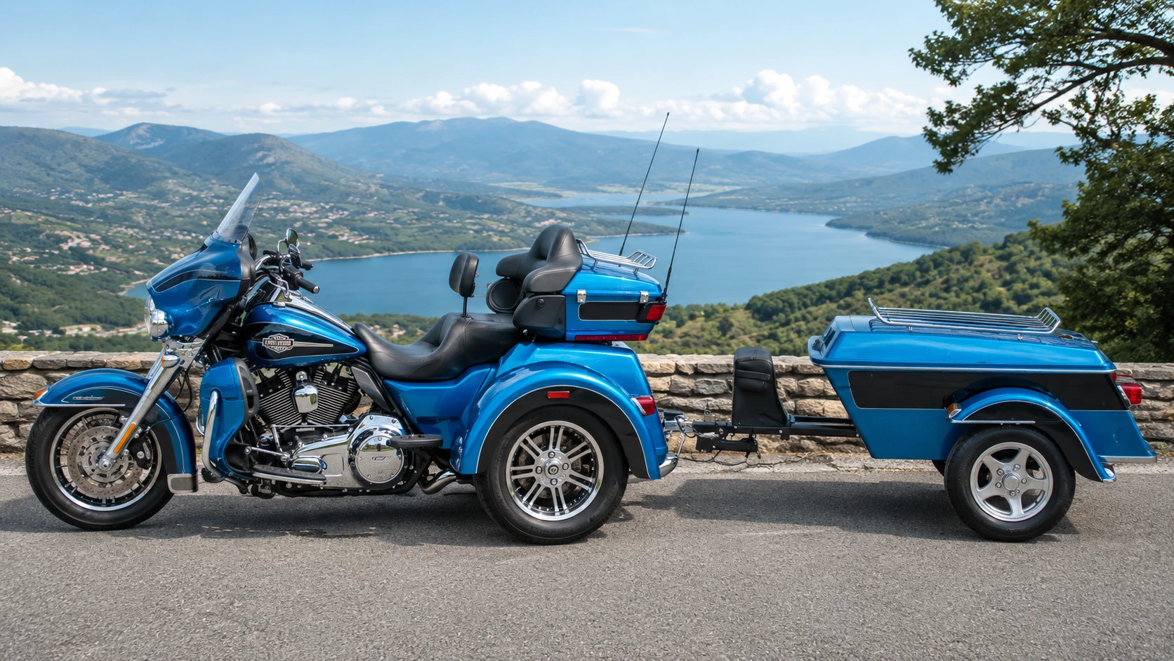 A blue Harley-Davidson trike motorcycle pulling a matching blue cargo trailer parked against a scenic lake