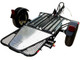 Side view of stand-up compact motorcycle trailer showing frame, wheel, and fender on pavement.