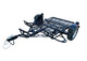 Front angled view of open Freestyle dirt bike trailer highlighting frame, wheel chocks, and loading area.