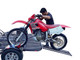 Bike being loaded onto the Freestyle dirt bike trailer using the extended ramp.