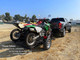 Freestyle dirt bike trailer hitched behind a truck, ready for transport with promotional text overlay.