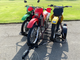 Freestyle dirt bike trailer viewed from the front angle, highlighting sturdy construction and front wheel supports.