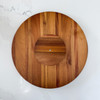 The underside of the Acacia Lazy Susan is shown, revealing the rotating base mechanism that allows for a smooth, 360-degree spin.