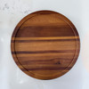 A top-down view of the round acacia wood lazy susan, providing a full view of its smooth surface and deep, natural wood patterns. Grain angel horizontal.