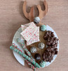 A beautiful holiday-themed food presentation on the Antler Acacia & Stone Round Board, featuring an assortment of appetizers that highlight the board's function as a unique and stylish serving piece.