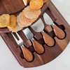 Top-down view of the round acacia cheeseboard set, beautifully styled with a variety of artisanal cheeses, crackers, and accompaniments.