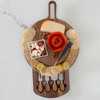 A stylish, round acacia wood cheeseboard is elegantly arranged with assorted cheeses, crackers, nuts, and a salami rose on a marble countertop, with its slide-out drawer open to reveal a set of cheese knives.