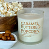 A Caramel Buttered Popcorn scented soy candle in a white frosted glass jar is styled for a cozy movie night, surrounded by a wooden bowl of popcorn and a small dish of caramel nuts. A Caramel Buttered Popcorn scented soy candle in a white frosted glass jar is styled for a cozy movie night, surrounded by a wooden bowl of popcorn and a small dish of caramel nuts.