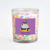A festive Cake Sprinkles Inclusion Candle in a clear glass jar, featuring a personalized purple label with a birthday cake illustration and the text "Happy Birthday Mrs. Jennings."