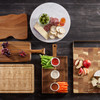 Charcuterie spread on acacia board with ramekins—meats, cheeses, and crackers styled for entertaining