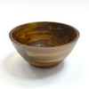 Side profile of the empty acacia wood serving bowl on a white surface.