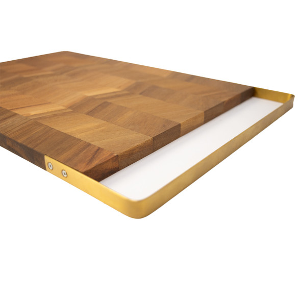 An angled view of the Acacia Chevron Board, highlighting its slim profile and the elegant design of the integrated stainless steel matte gold handle.
