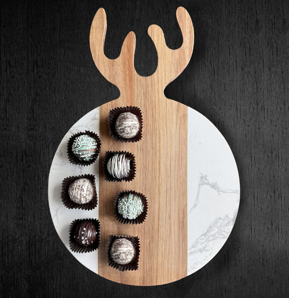 A round serving board, crafted from a beautiful mix of acacia wood and white quartz stone, features a unique antler-shaped handle and is elegantly styled with an array of gourmet chocolate truffles on a dark, textured background. A round serving board, crafted from a beautiful mix of acacia wood and white quartz stone, features a unique antler-shaped handle and is elegantly styled with an array of gourmet chocolate truffles on a dark, textured background.