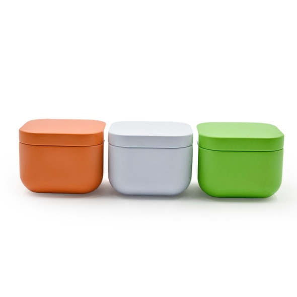 The three square candle tins are lined up horizontally against a white background, clearly displaying the summer color palette of orange, white, and lime green. The three square candle tins are lined up horizontally against a white background, clearly displaying the summer color palette of orange, white, and lime green.