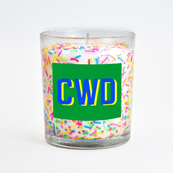 The sprinkles inclusion candle is displayed with a custom green label featuring the personalized initials "CWC."