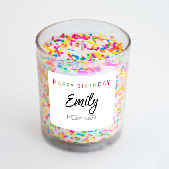 An angled view of the personalized birthday candle, highlighting the colorful, real sprinkles embedded in the wax.
