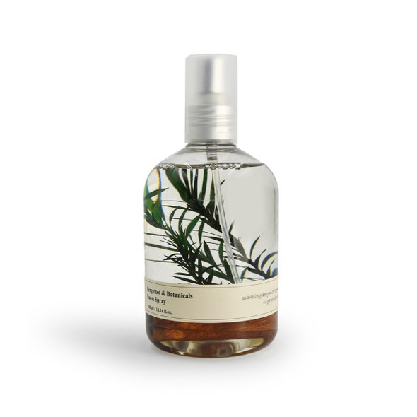 A clear, isolated product shot of the Bergamot & Botanicals Room Spray against a plain white background, showing the full bottle with its silver spray pump and botanical inclusions. A clear, isolated product shot of the Bergamot & Botanicals Room Spray against a plain white background, showing the full bottle with its silver spray pump and botanical inclusions.