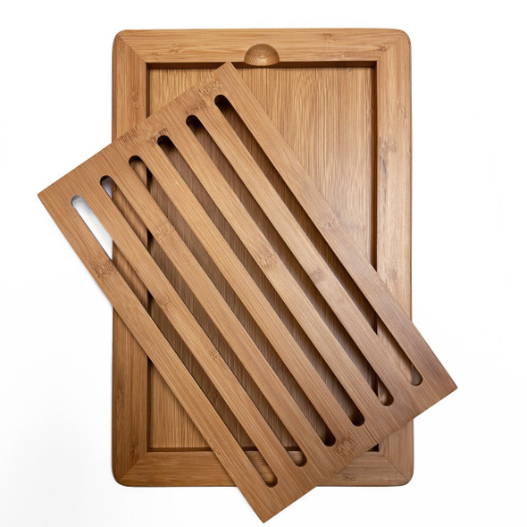 Angled view of the bamboo bread board showing the removable slatted insert lifted from the base. Angled view of the bamboo bread board showing the removable slatted insert lifted from the base.