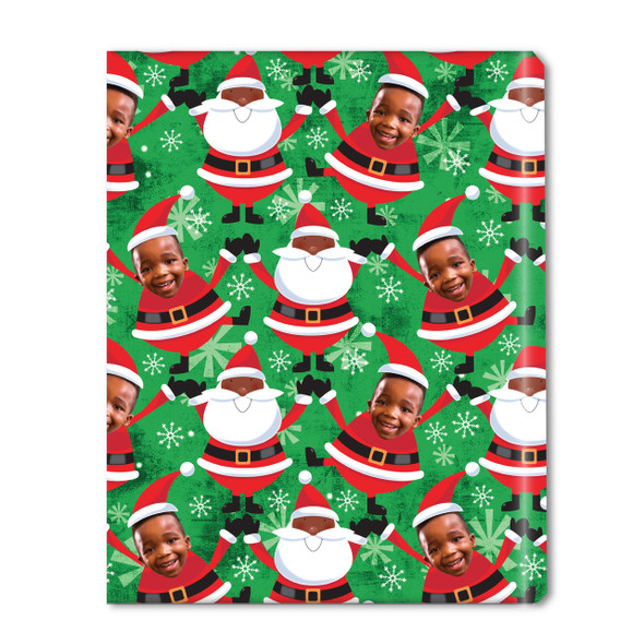 A roll of personalized Christmas gift wrap featuring a festive green background with a repeating pattern of cartoon Santas and a custom photo of a smiling child's face integrated into a Santa character.