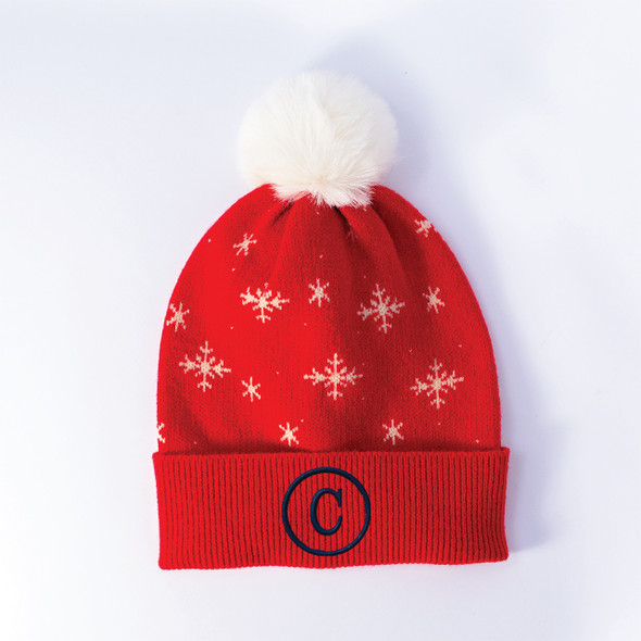 Red knit beanie with white snowflakes, white faux-fur pom-pom, and navy embroidered monogram on the cuff Red knit beanie with white snowflakes, white faux-fur pom-pom, and navy embroidered monogram on the cuff