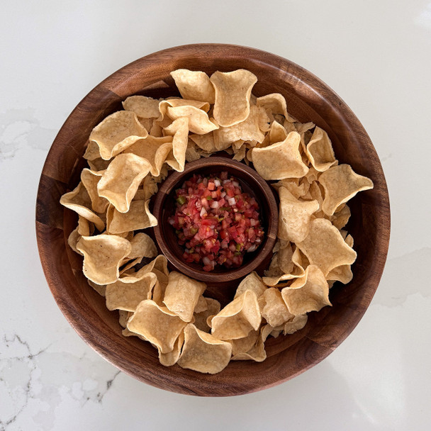 A top-down view of the acacia chip and dip platter filled with chips and salsa, showcasing it as the perfect centerpiece for serving appetizers.
