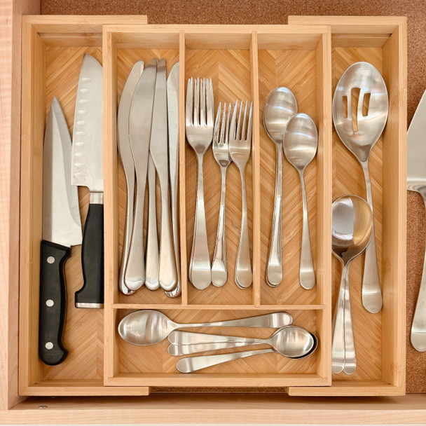 The bamboo bag organizer is shown inside a slightly open kitchen drawer filled with household items, demonstrating how it creates a tidy, clutter-free space.