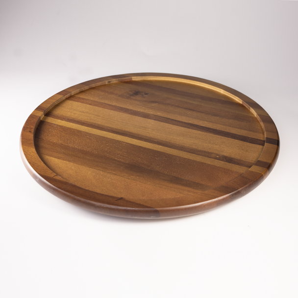An angled view of the empty Acacia Lazy Susan, highlighting the beautiful, rich grain and warm tones of the natural acacia wood and its raised edge design.