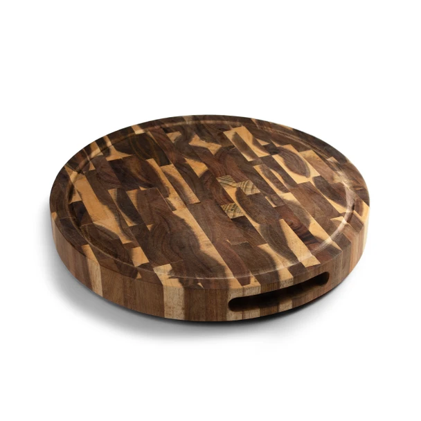 An angled, clear view of the thick, round Acacia End Grain Board, showcasing its stunning, varied wood grain pattern, integrated side grips for easy lifting, and a perimeter juice groove.