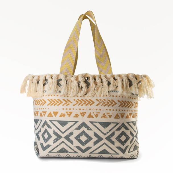 The stylish Luna Tassels Large Boho Tote, featuring a handwoven, earthy geometric pattern, fringe tassel trim, and yellow chevron-patterned handles, is shown against a plain white background.