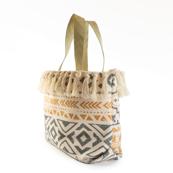 A three-quarter view of the Luna Tassels tote bag, highlighting its unique geometric design, tassel details, and sturdy woven handles.