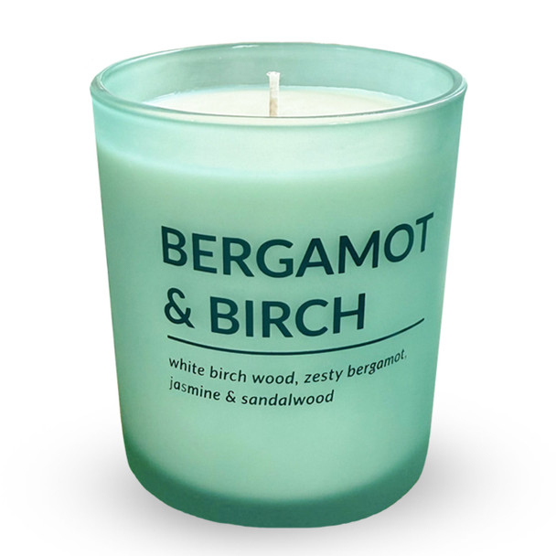 A clear product shot of the Bergamot & Birch candle in its matte green glass jar, shown against a plain white background to highlight its clean, modern design.
