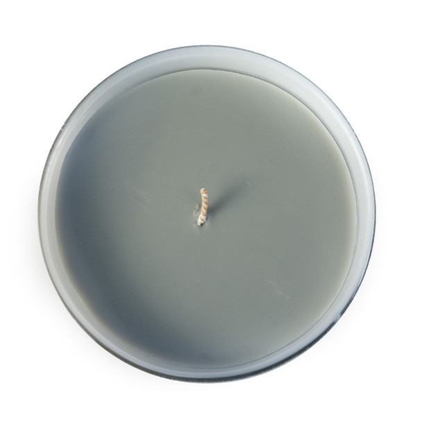 A top-down view of the unlit candle, showing the single lead-free wick and the tranquil gray-green color of the soy wax.